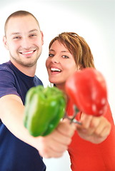 Image showing happy couple with peppers isolated