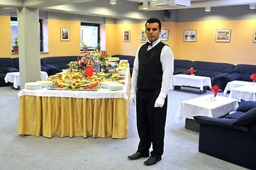 Image showing Young waiter in reataurant