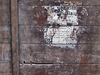 Image showing Poster remains on wooden surface