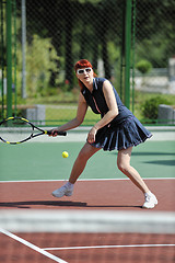 Image showing young woman play tennis game outdoor