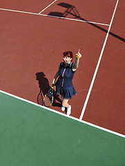 Image showing young woman play tennis game outdoor