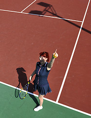 Image showing young woman play tennis game outdoor