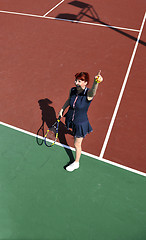 Image showing young woman play tennis game outdoor