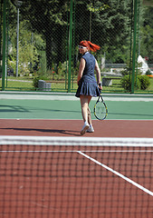 Image showing young woman play tennis game outdoor