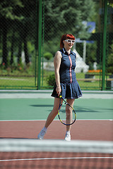 Image showing young woman play tennis game outdoor