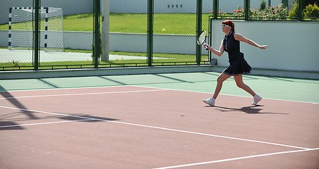 Image showing young woman play tennis game outdoor