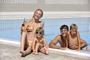 Image showing happy young family have fun on swimming pool