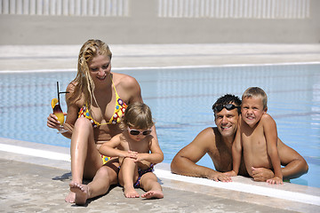 Image showing happy young family have fun on swimming pool