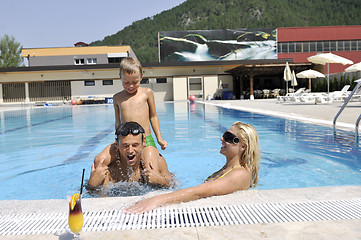 Image showing happy young family have fun on swimming pool