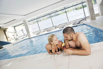 Image showing happy cople relaxing  at swimming pool