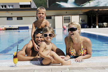 Image showing happy young family have fun on swimming pool