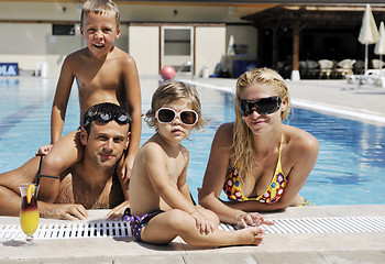 Image showing happy young family have fun on swimming pool