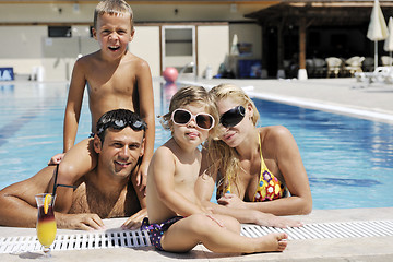 Image showing happy young family have fun on swimming pool