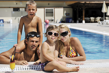 Image showing happy young family have fun on swimming pool