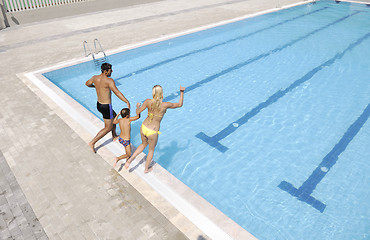 Image showing happy young family have fun on swimming pool