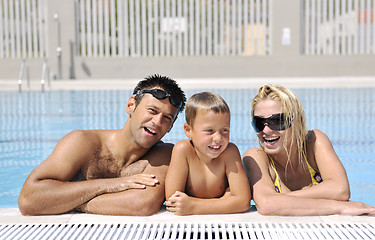 Image showing happy young family have fun on swimming pool