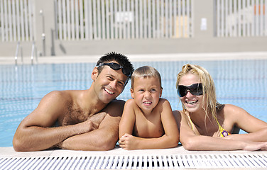 Image showing happy young family have fun on swimming pool