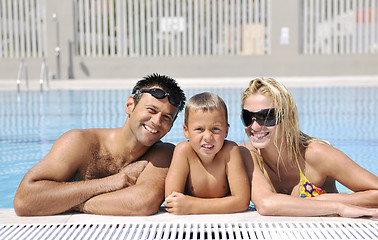 Image showing happy young family have fun on swimming pool