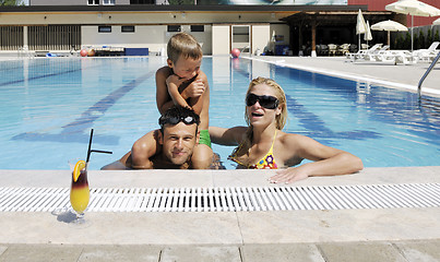 Image showing happy young family have fun on swimming pool