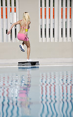 Image showing woman fitness exercise at poolside