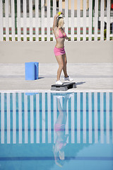 Image showing woman fitness exercise at poolside