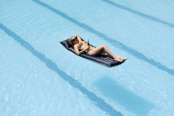 Image showing beautiful woman relax on swimming pool