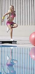 Image showing woman fitness exercise at poolside