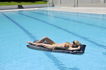 Image showing beautiful woman relax on swimming pool