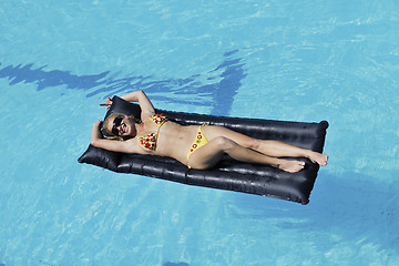 Image showing beautiful woman relax on swimming pool