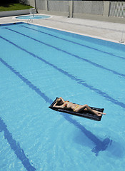 Image showing beautiful woman relax on swimming pool