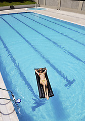 Image showing beautiful woman relax on swimming pool