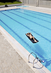 Image showing beautiful woman relax on swimming pool