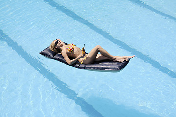 Image showing beautiful woman relax on swimming pool