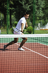 Image showing young man play tennis outdoor