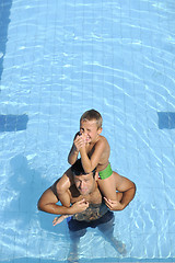 Image showing happy father and son at swimming pool