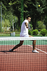 Image showing young man play tennis outdoor