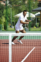 Image showing young man play tennis outdoor