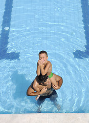 Image showing happy father and son at swimming pool