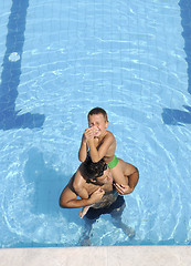 Image showing happy father and son at swimming pool