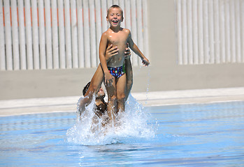 Image showing happy father and son at swimming pool