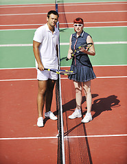 Image showing happy young couple play tennis game outdoor