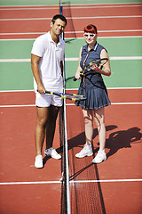 Image showing happy young couple play tennis game outdoor