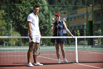 Image showing happy young couple play tennis game outdoor