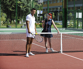 Image showing happy young couple play tennis game outdoor