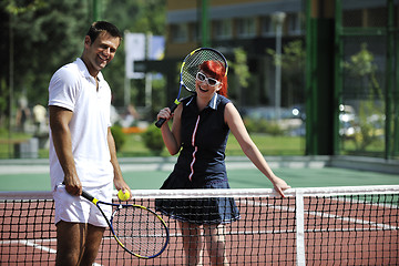 Image showing happy young couple play tennis game outdoor