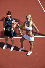 Image showing happy young couple play tennis game outdoor