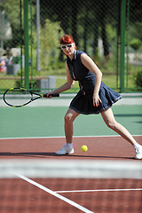 Image showing young woman play tennis game outdoor