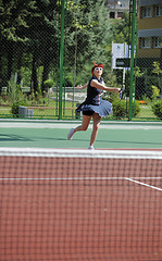 Image showing young woman play tennis game outdoor