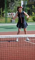 Image showing young woman play tennis game outdoor