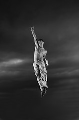 Image showing young man dancing and jumping  on top of the building 